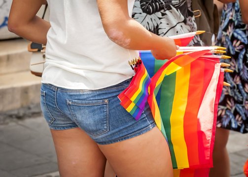 TEL AVIV, ISRAEL. June 9, 2017. Girl selling LGBT rainbow flags in the street due to the Gay Pride Parade in Tel Aviv 2017.