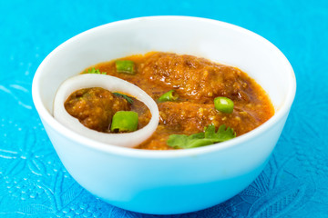 Malai Kofta or meatballs - Traditional Indian food  clicked on a blue background