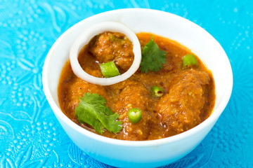 Malai Kofta or meatballs - Traditional Indian food  clicked on a blue background