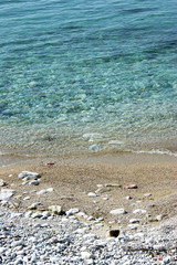 Pebble beach and clear sea water