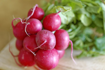 Close-up of raw radish on a wooden board. Selective focus and shallow depth of field.