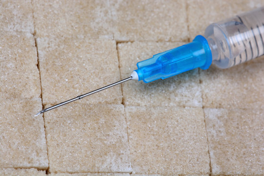 Beige sugar cubes with syringe