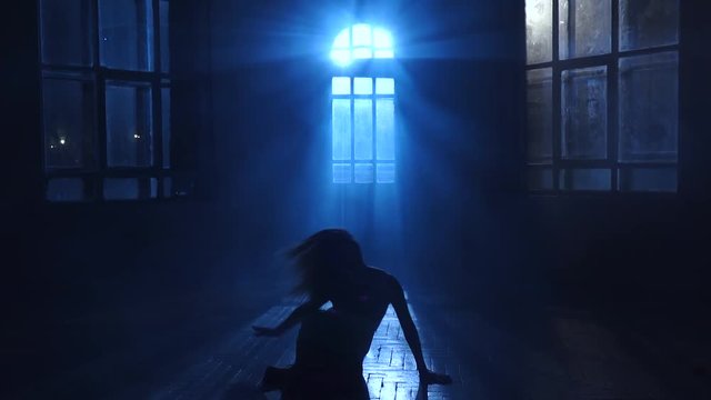 Girl teenage dances the moonlight penetrates through the window. Silhouette