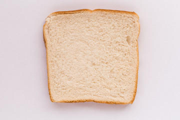 Slice of white bread on white background