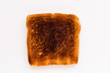 Burnt slice of white bread on white background