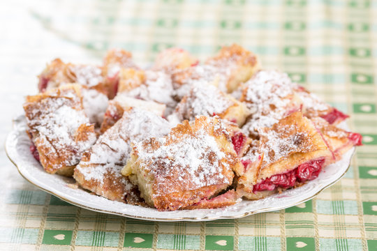 Cherry cake with powdered sugar on the plate