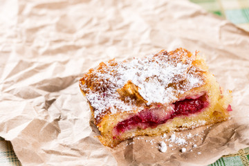 Closeup of homemade cherry cake with powdered sugar on the plate