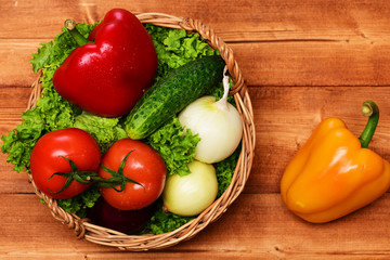 farming concept, vegetables, lettuce, tomatoes, onions, peppers, cucumber in basket