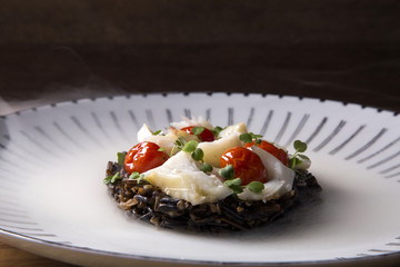 Black rice risotto with shredded cod