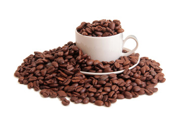 Coffee beans and a white cup on white background