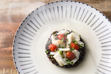 Black rice risotto with shredded cod