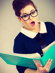 Shocked business woman looking at documents