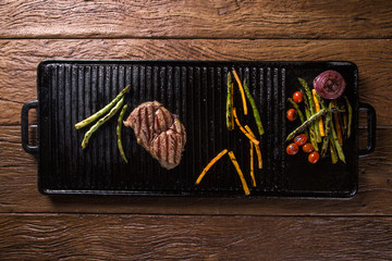 Ancho steak with grilled vegetables on the grill