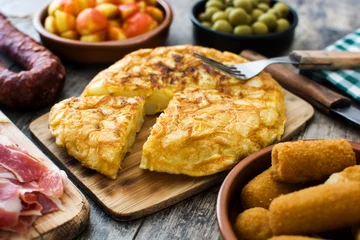 Foto op Canvas Traditional spanish tapas. Croquettes, olives, omelette, ham and patatas bravas on wooden table   © chandlervid85