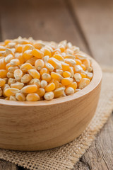 corn cereal organic in bowl on wood background vertical view