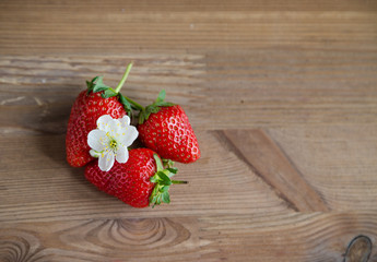 Fresh and ripe strawberries on a wooden background Summer food concept Copy space