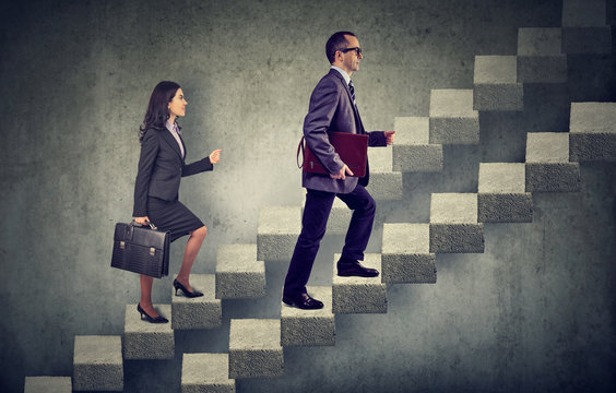 Business Woman And Man With Briefcase Stepping Up A Stairway Career Ladder