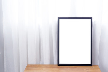 Empty black frame with place for text of on table. Scandinavian hipster style room interior.