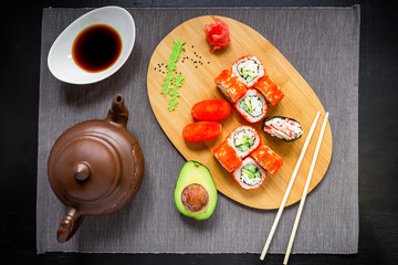 Fototapeta na wymiar Sushi rolls, soy sauce, ginger and chopsticks. Top view. Flat lay. Japanese traditional food