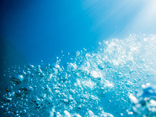 Fototapeta na wymiar Underwater blue ocean texture. Bubbles in tropical sea.