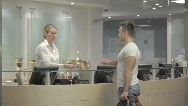 The hostesses give the keys from the room in the hotel