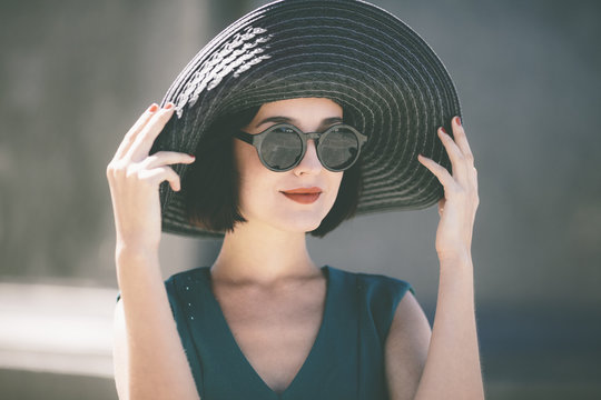 trendy young woman wearing hat 