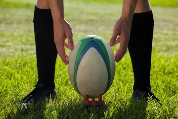 Low section of rugby player getting ready to kick for goal - Powered by Adobe
