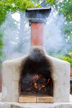 Pizzas baking in an open firewood oven
