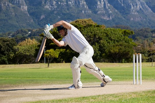 Full length of cricketer playing on field - Powered by Adobe