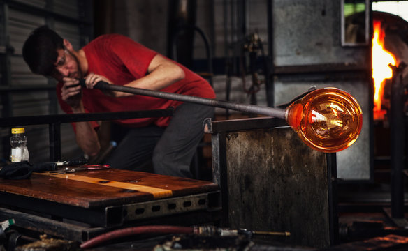 Glass Artist Blows Through Pipe To Shape Glass