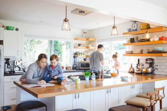 Cool, young family spending time together in bright, modern kitchen