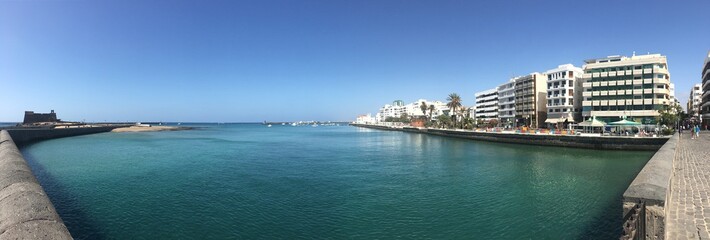 Panoramic view of the clear aqua blue waters  of the Arrecife Harbor in Lanzarote, Canary Islands, Spain
