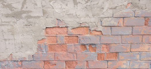 Painted distressed grunge brickwall background. Shabby building facade with plaster.
