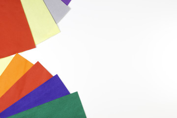 Selection of colorful felt sheets arranged as border frame on white background