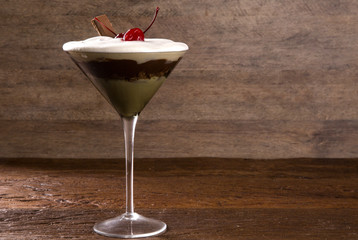 Delicious Italian dessert Pannacotta with chocolate and cherry