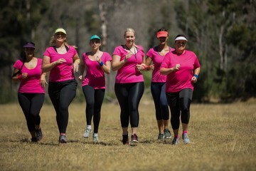 Fototapeta premium Group of women jogging together in the boot camp