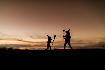mother with daughter playing at halloween night
