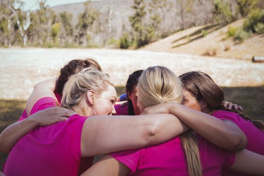 Group of women forming huddles in the boot camp - Powered by Adobe