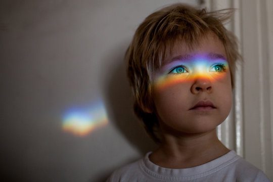 Little girl with a rainbow of light across her eyes