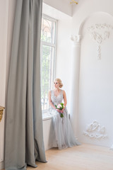 Fototapeta premium Fashion bride in gray dress with make-up smoky eyes