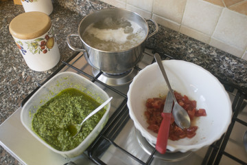 cooking pasta pesto sauce and tomatoes