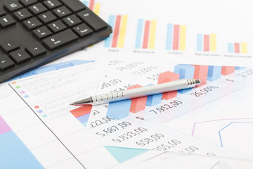 Financial printed paper charts, graphs on desk