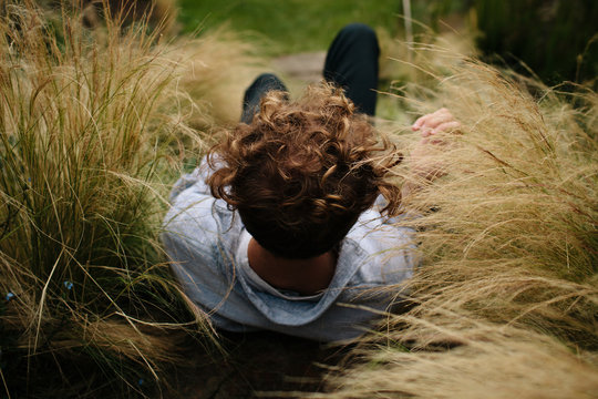 Male model sitting in long grass