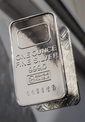 Minted silver bar weighing one troy ounce. The texture of the surface of the silver ingot..