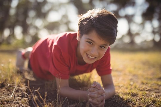 Portrait Of Happy Kid Performing Exercise During Obstacle Course