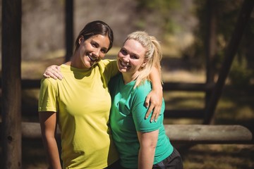 Portrait of happy friends standing with arms