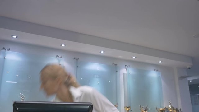 Hostesses looking in the telephone on the working place in the hotel