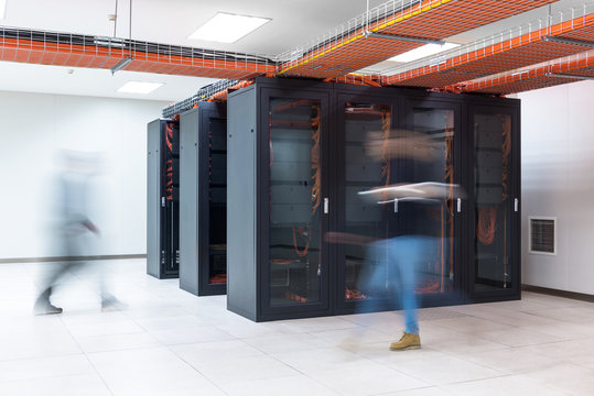 BLurred motion of people walking in a server room