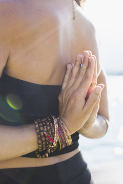 Woman practicing yoga reverse prayer hands