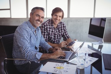 Portrait of businessmen working at creative office